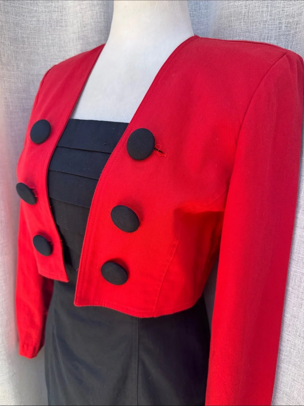 Jillian Arthur 1990s black strapless dress paired with a red bolero crop blazer